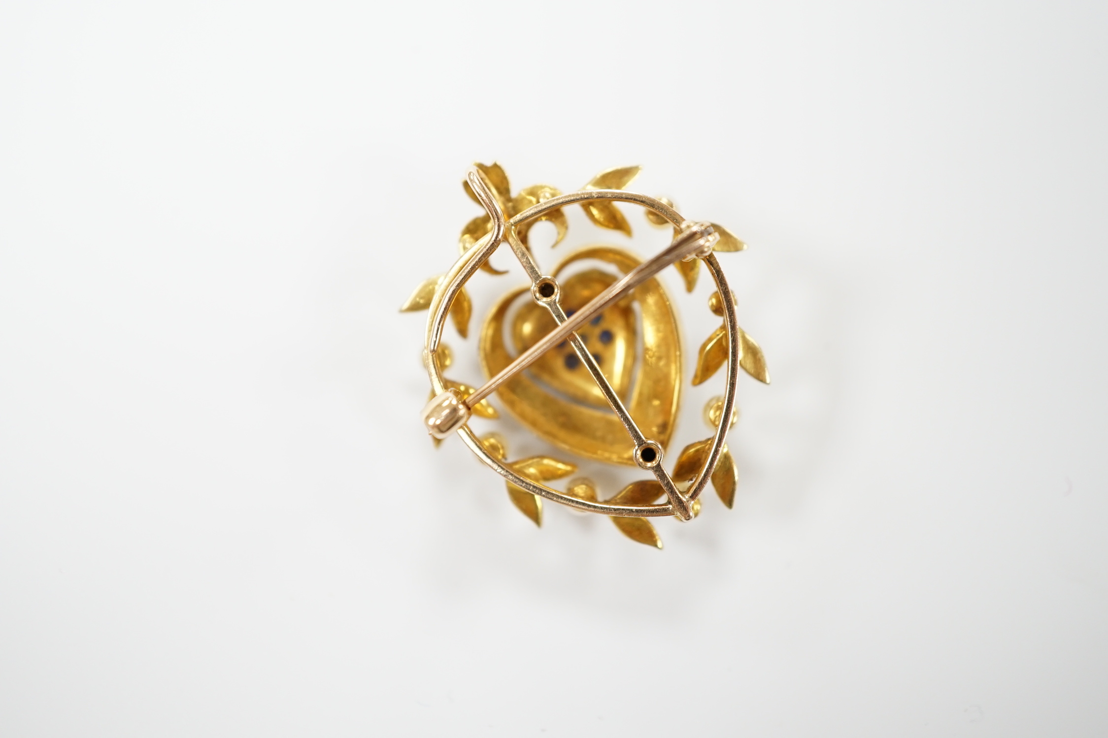 A yellow metal, sapphire, diamond and seed pearl set pendant brooch, with central heart motif, 30mm, gross weight 6.8 grams.